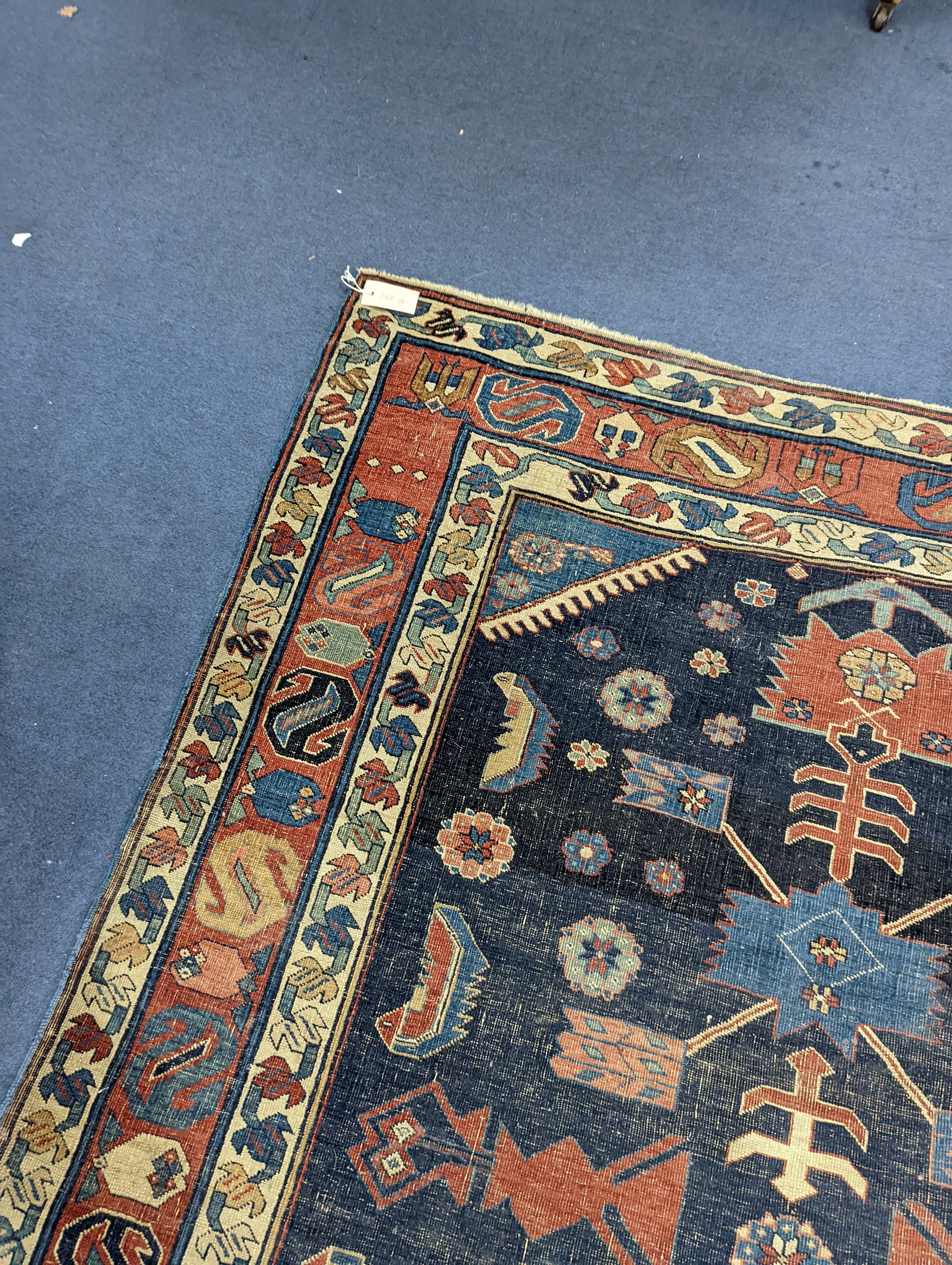 An antique Caucasian blue ground rug (worn), 200 x 148cm